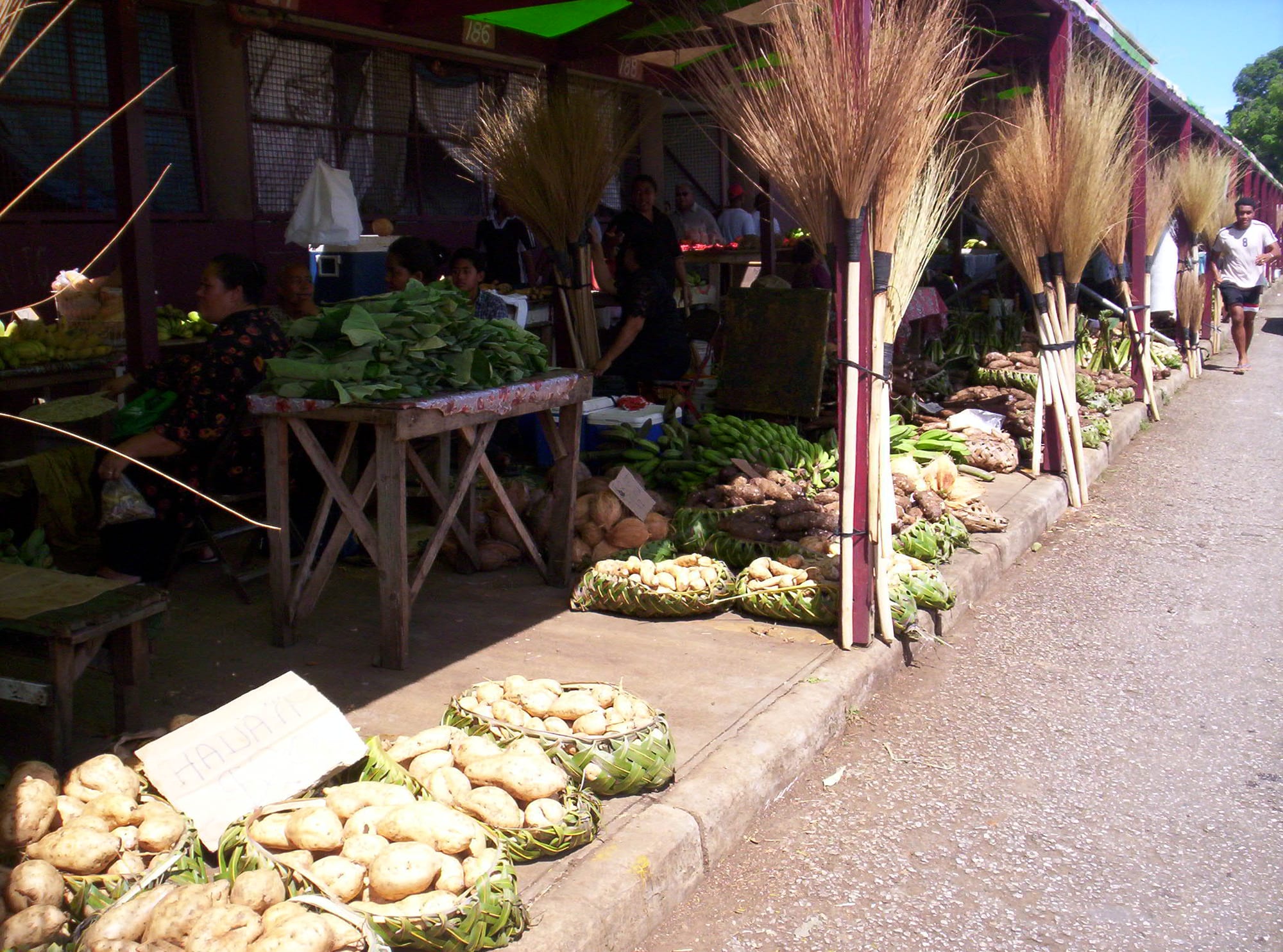An indoor market with produce stalls