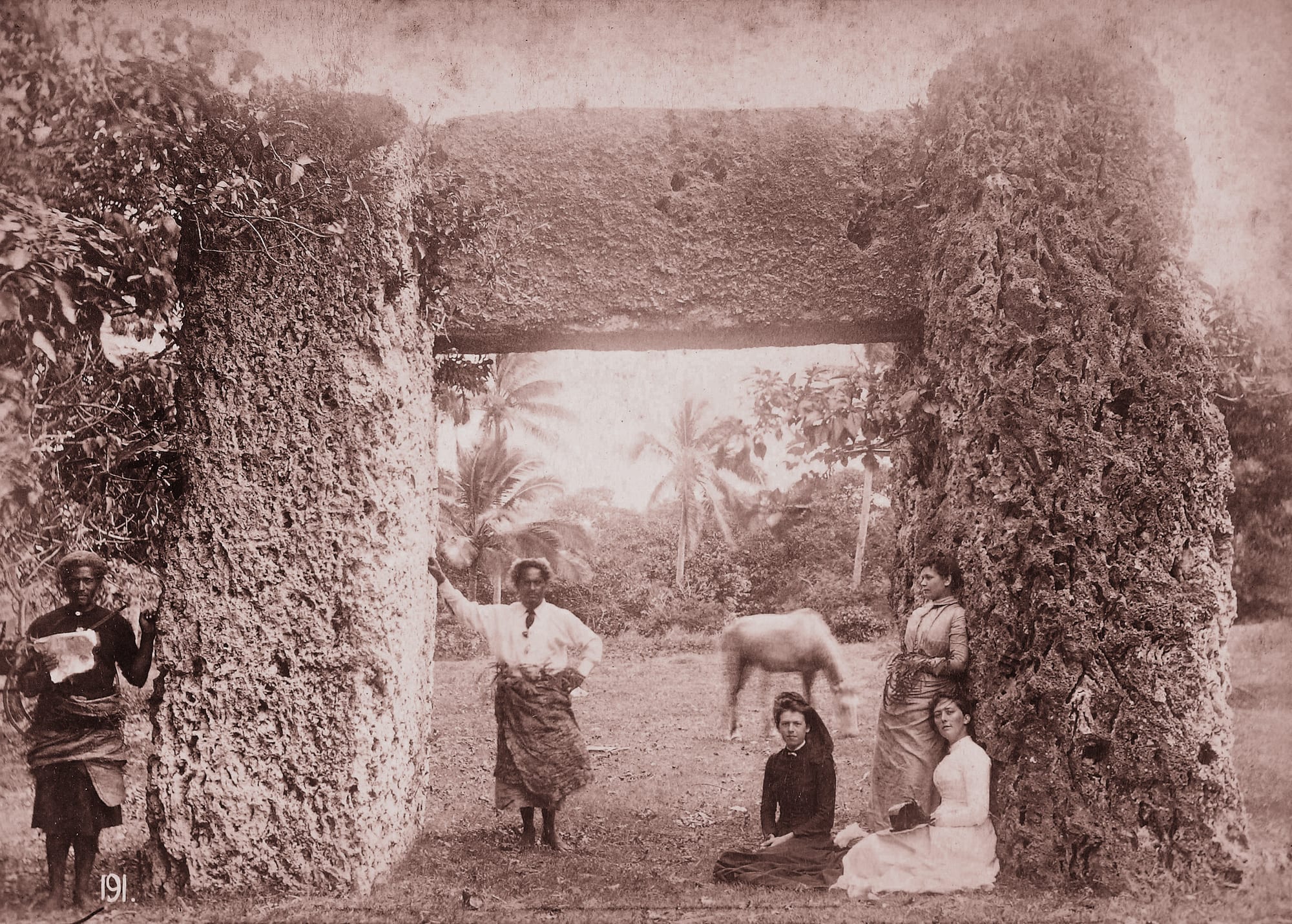 Three large upright coral-limestone slabs forming a doorway-like trilithon, photographed in the 1880s
