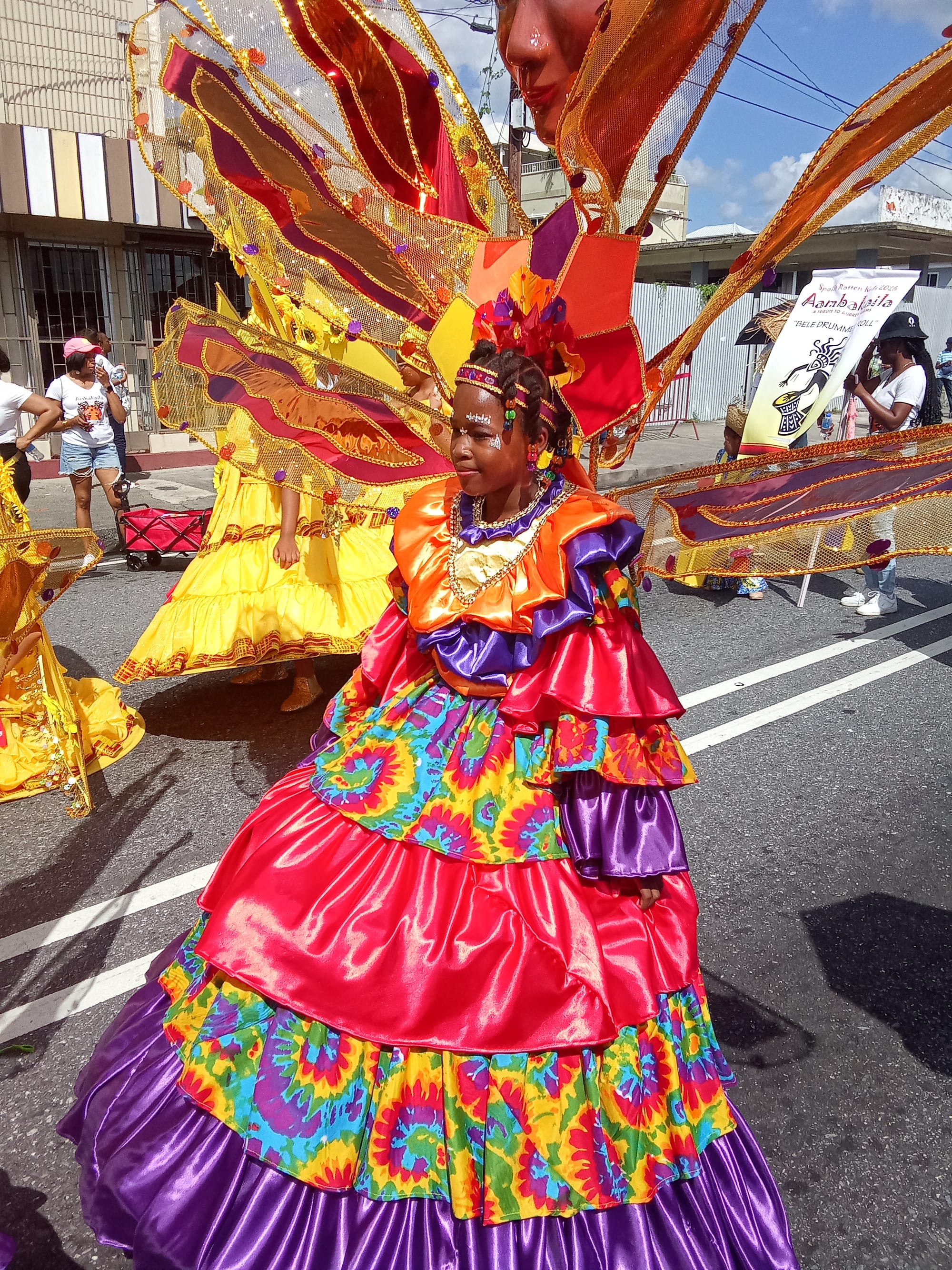Performers in elaborate, colourful feathered Carnival costumes