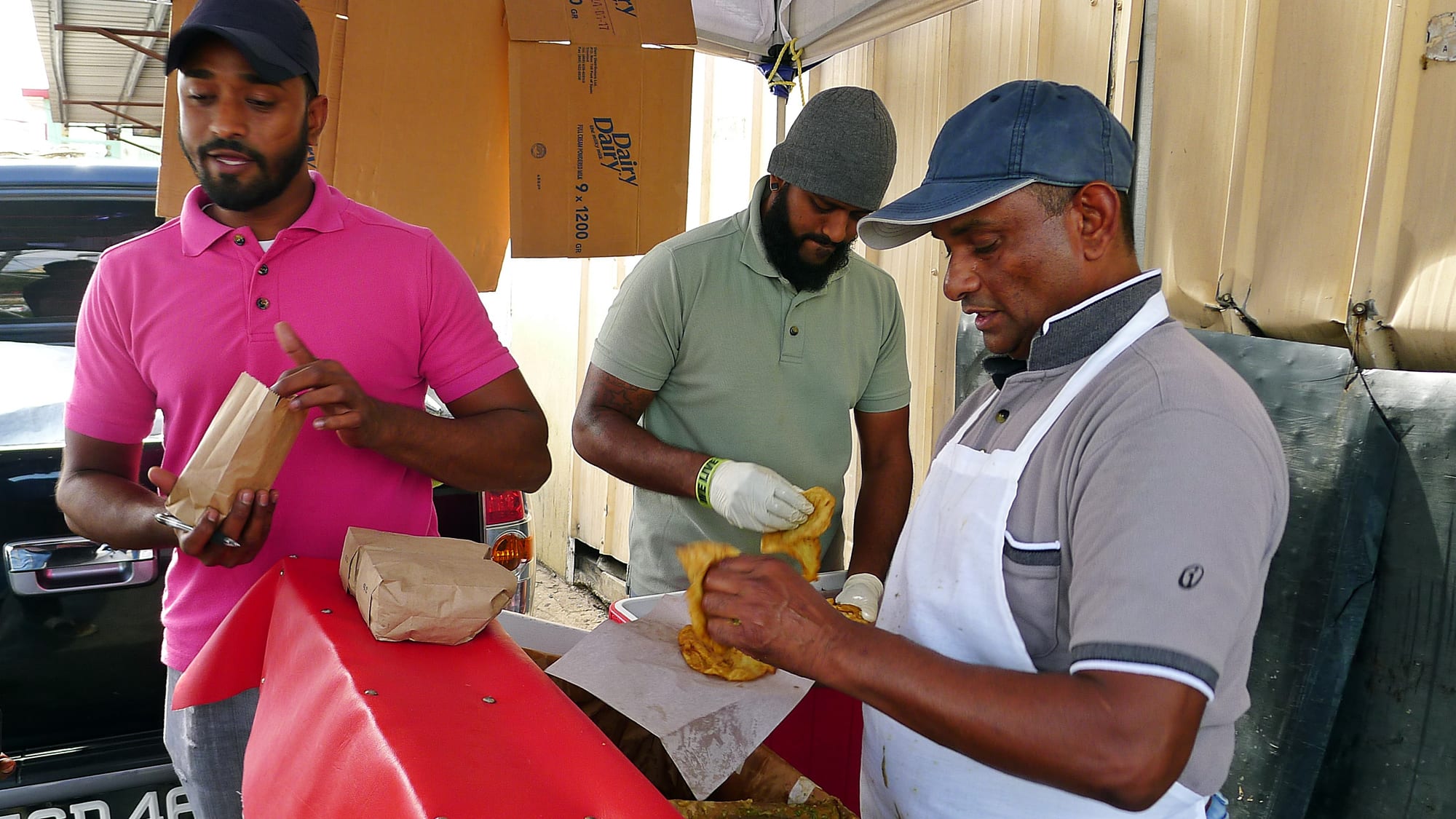 A street food vendor preparing food at a stall
