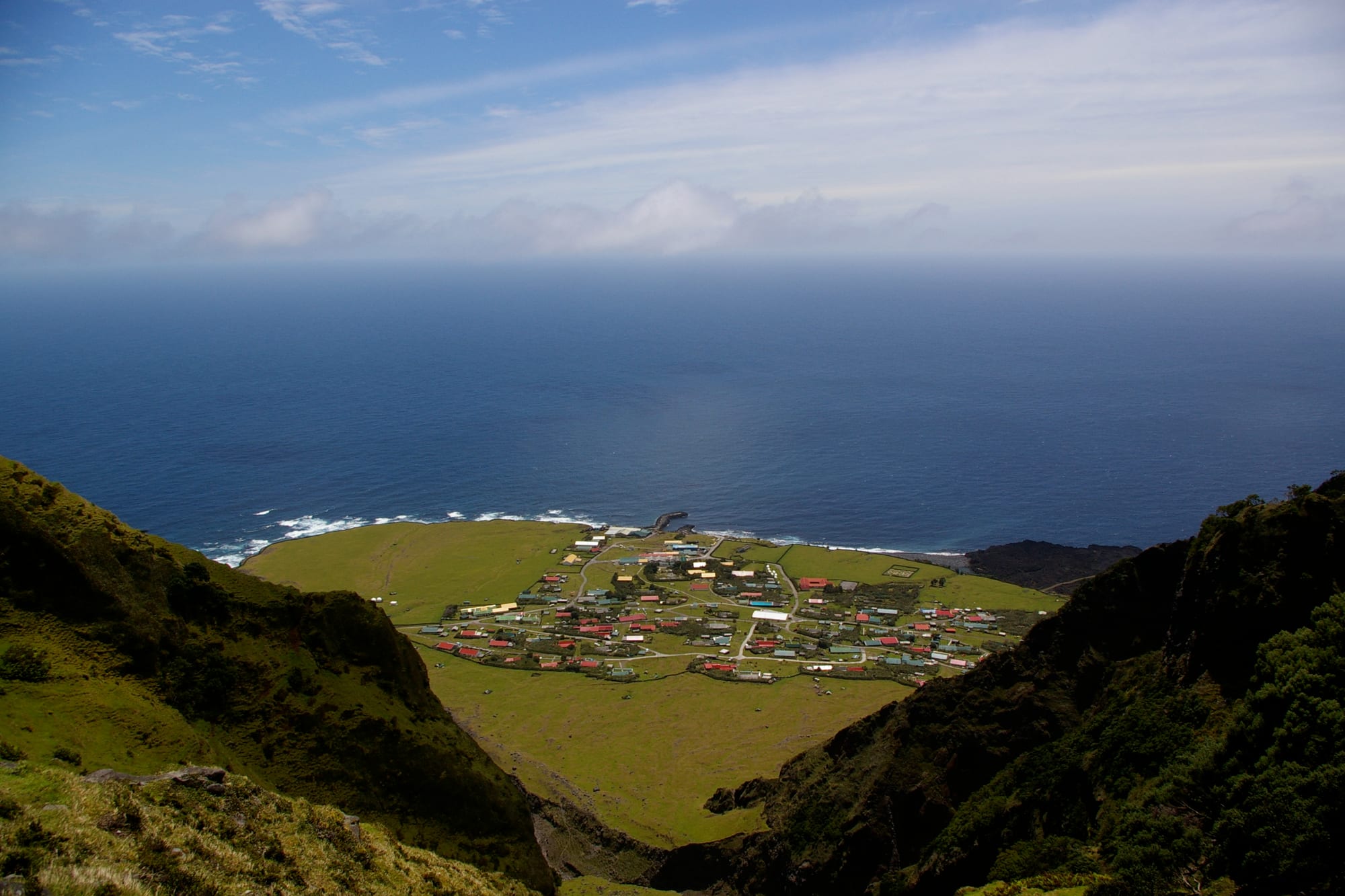 A rugged coastal landscape with a research station