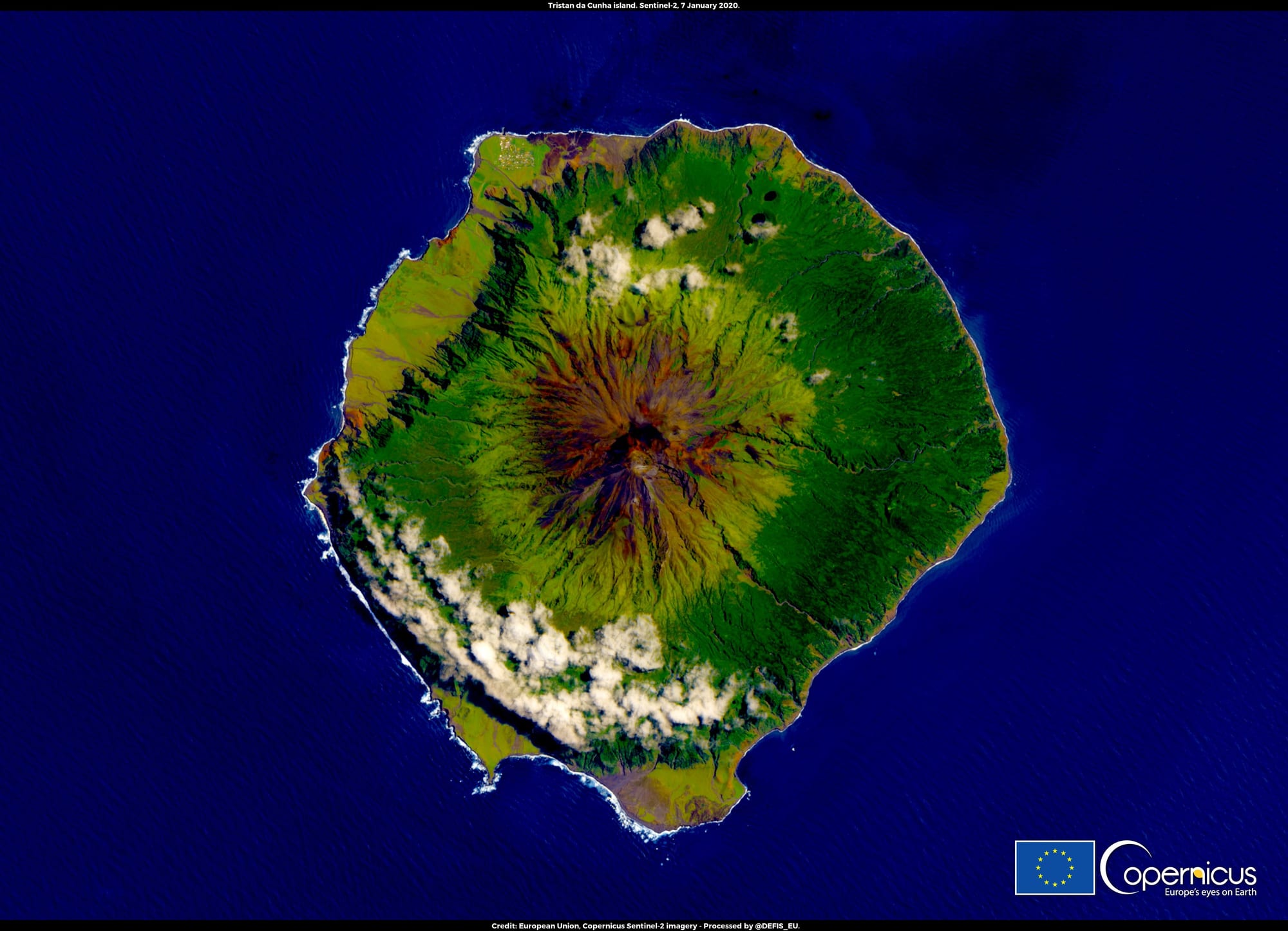 A satellite view of an isolated volcanic island surrounded by open ocean