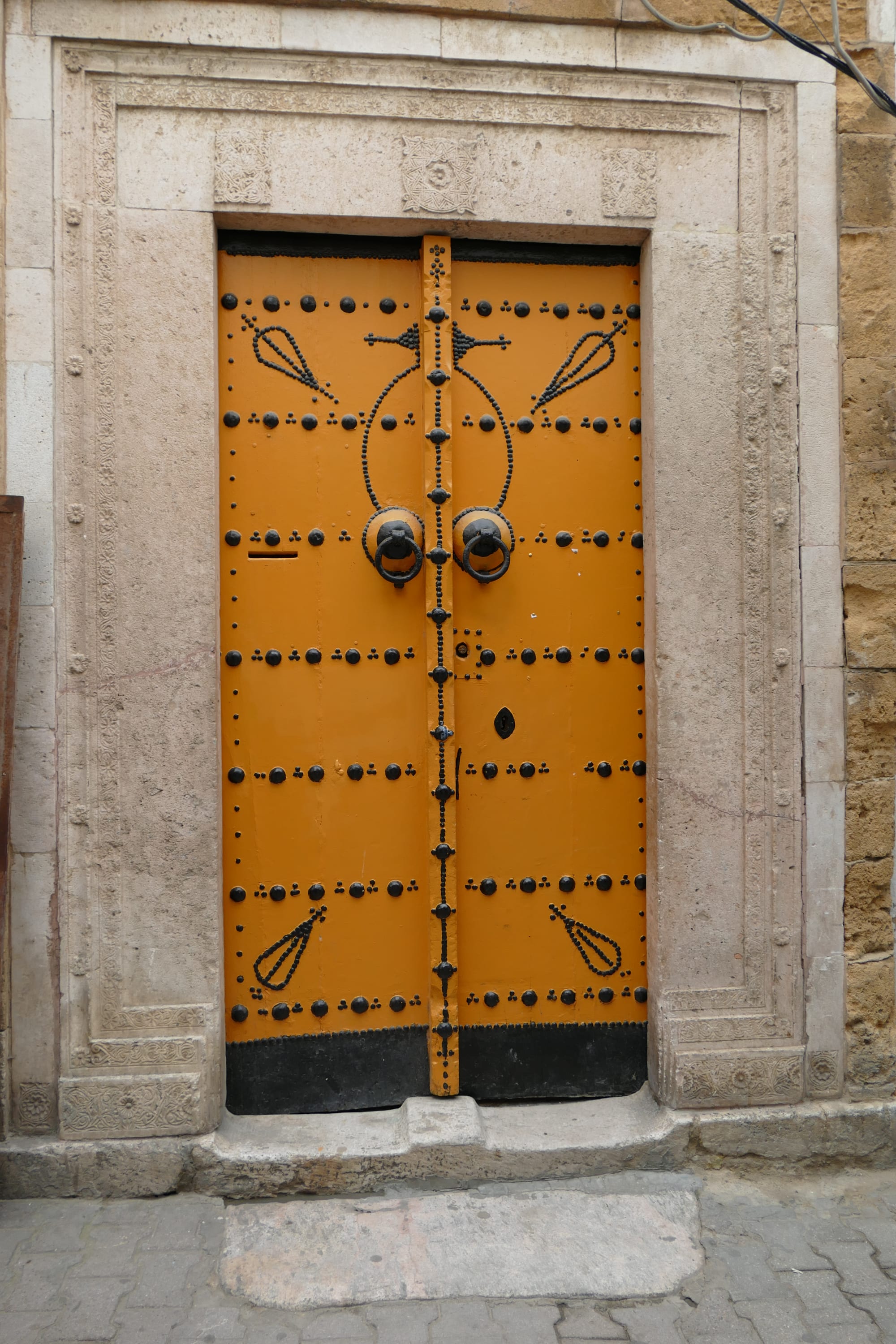An ornately decorated traditional door within a historic market quarter