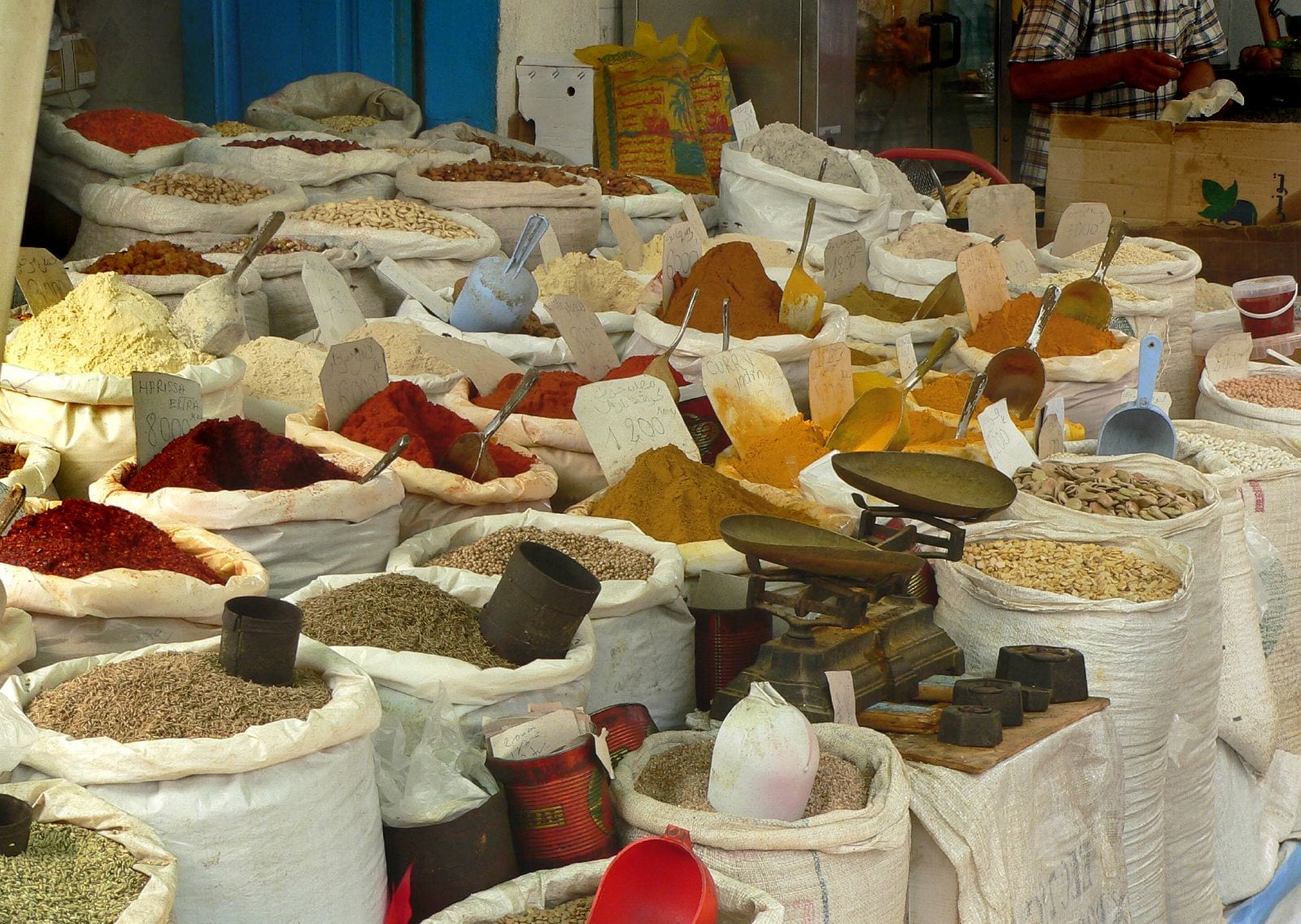 A spice market with vendors and colourful spice displays