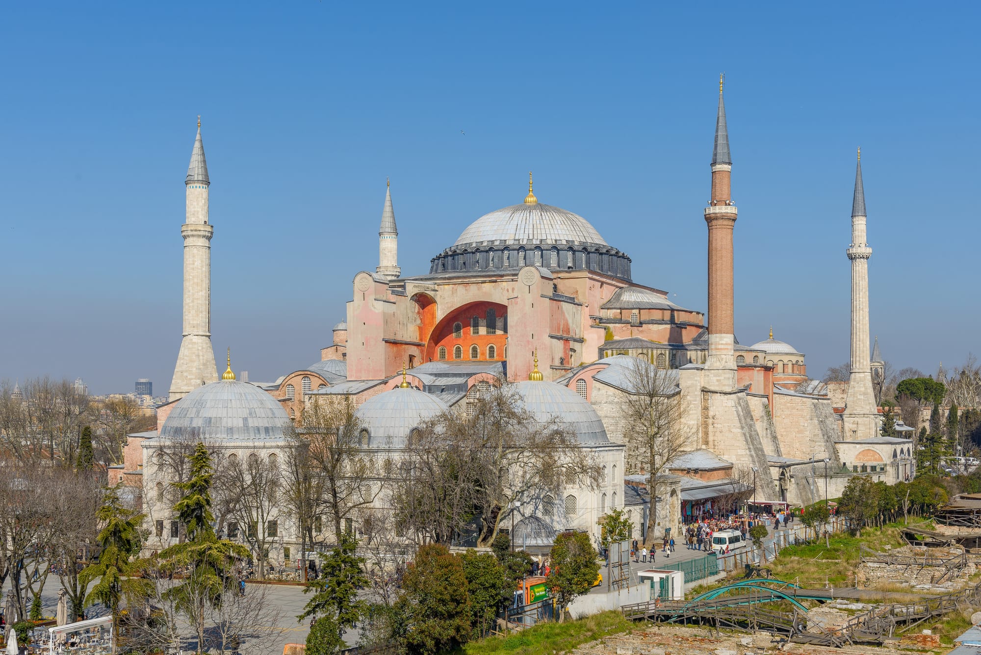 A massive domed former cathedral with minarets rising above a historic city