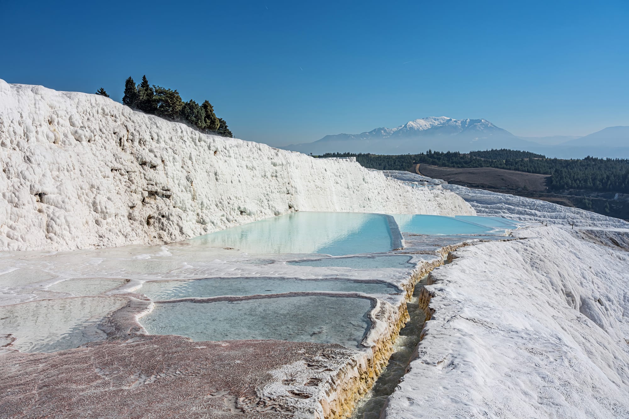 Brilliant white mineral terraces filled with pools of turquoise water