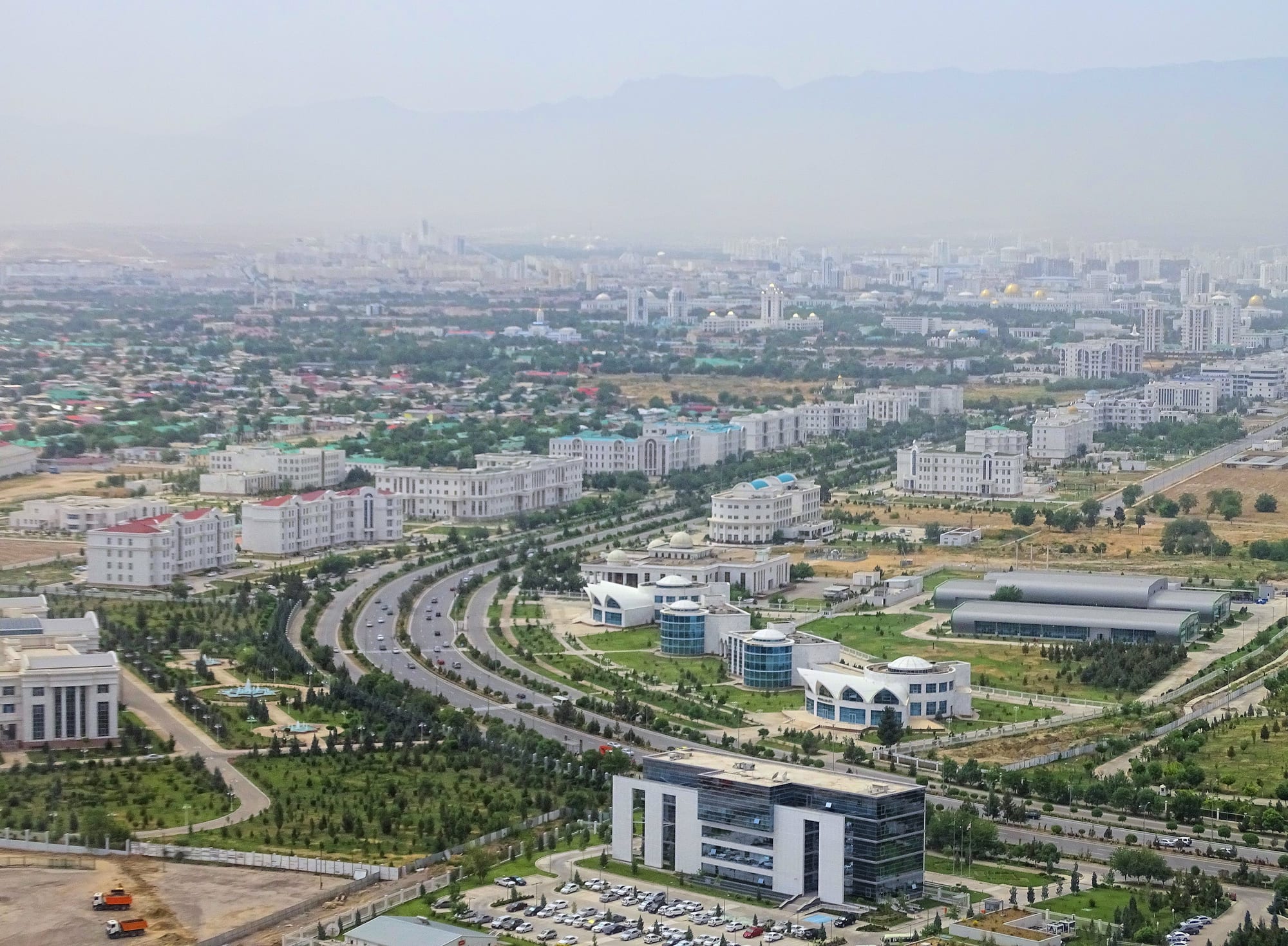 A wide boulevard lined with gleaming white marble buildings