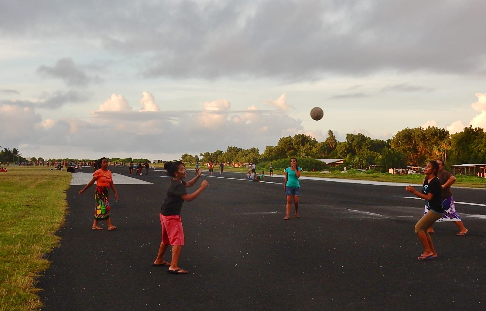 Children playing sports on an airport runway