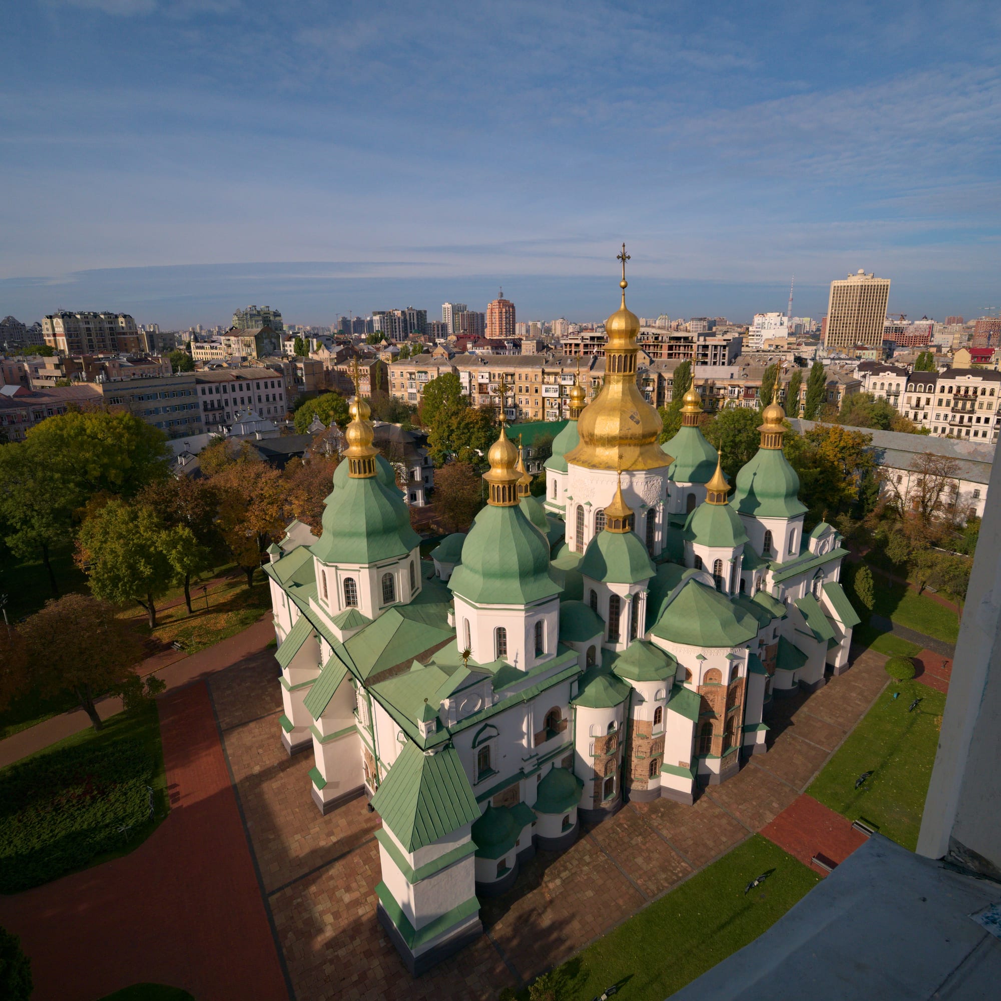 A grand cathedral with golden domes and a bell tower
