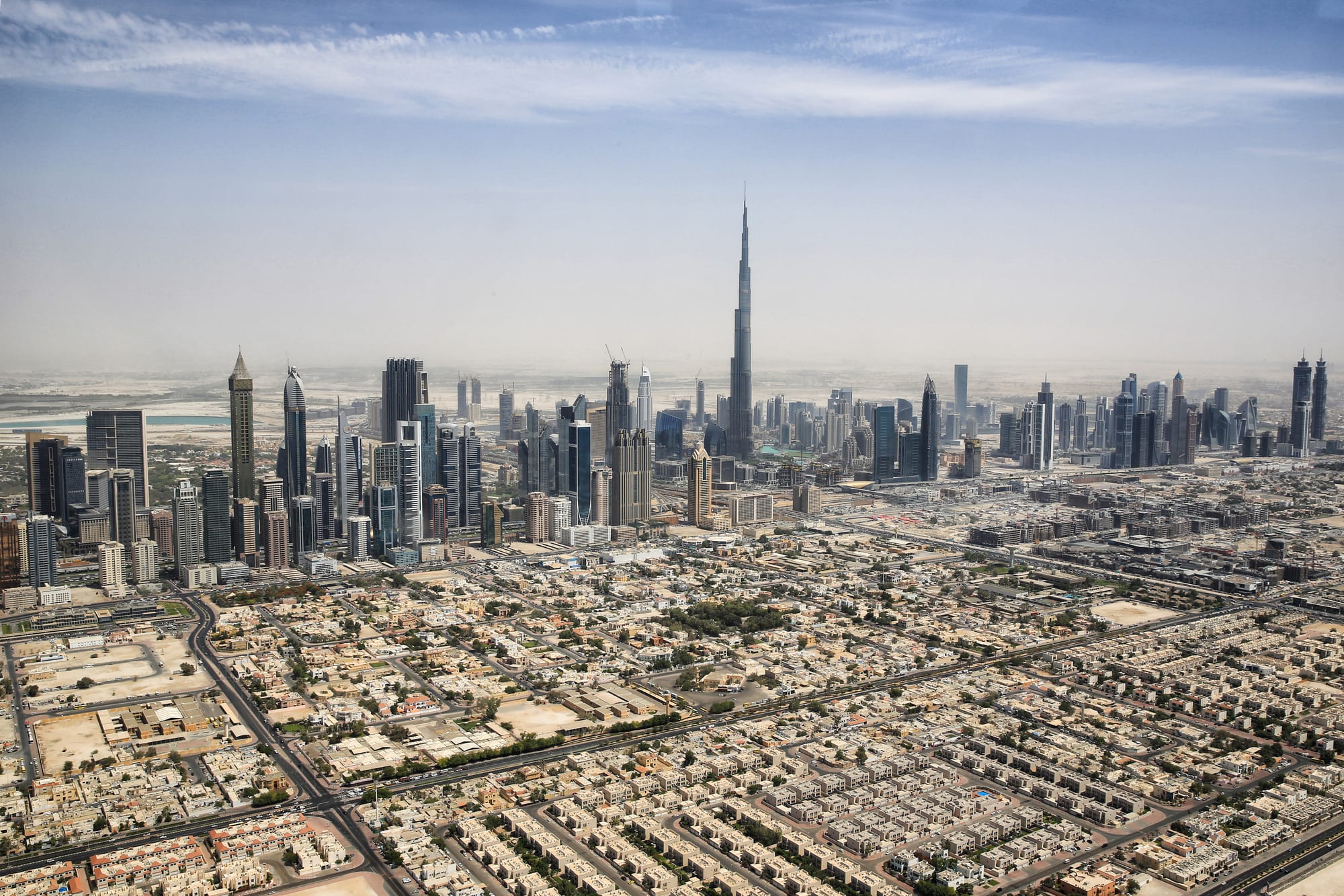 The Dubai skyline dominated by the needle of the Burj Khalifa rising far above a field of towers