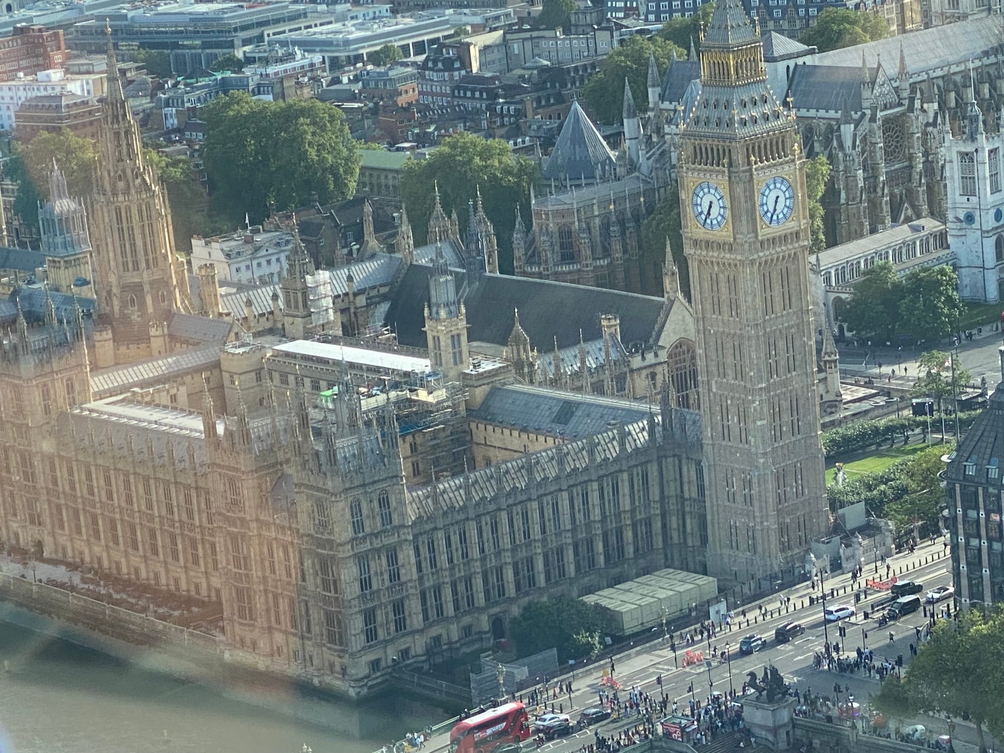 A grand Gothic clock tower and parliament building beside a river