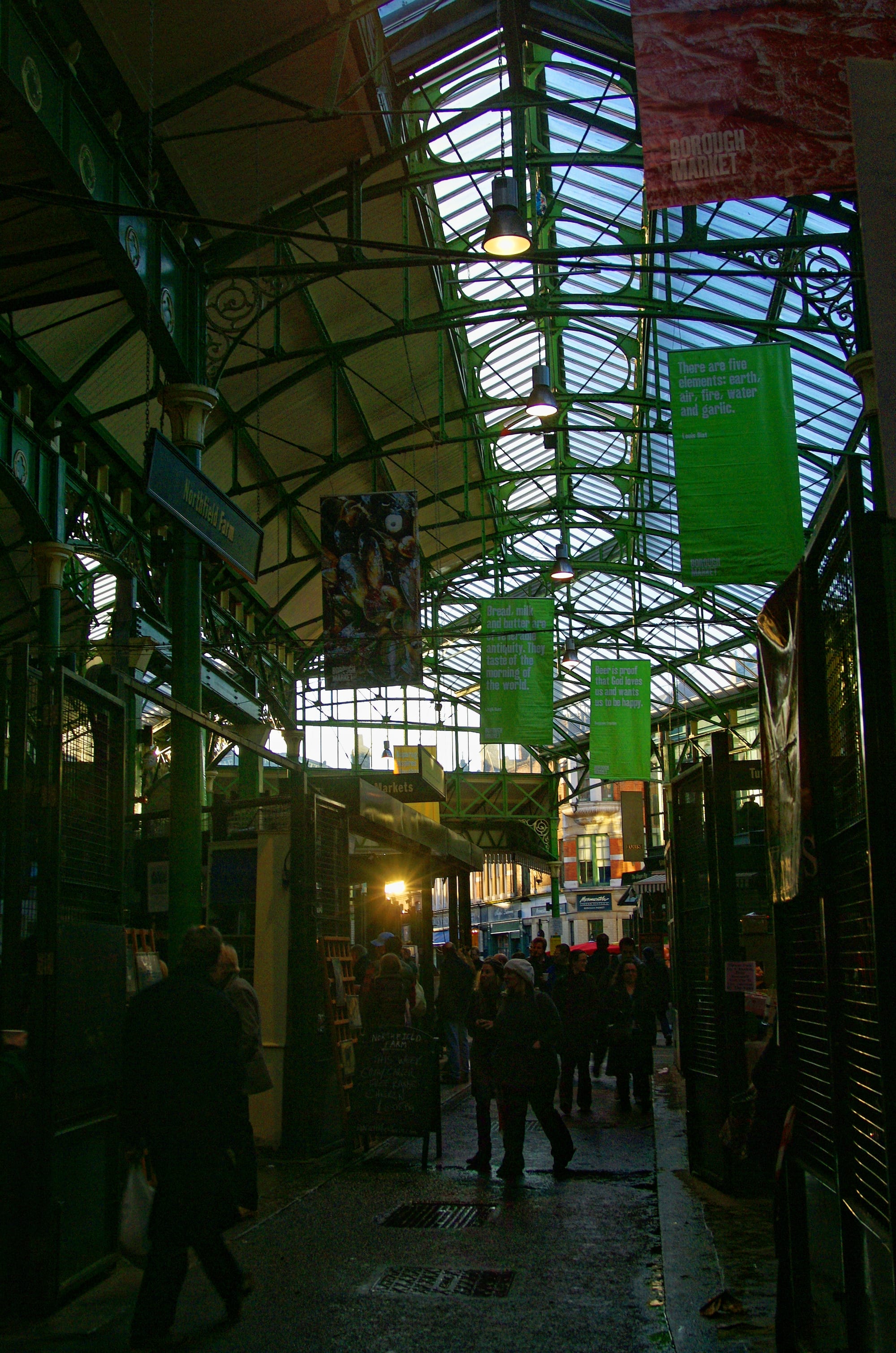 A busy covered food market with stalls