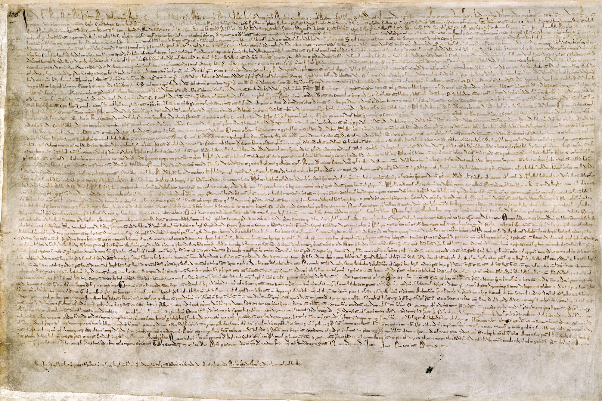 A densely written medieval Latin document on vellum, one of the original 1215 copies of Magna Carta