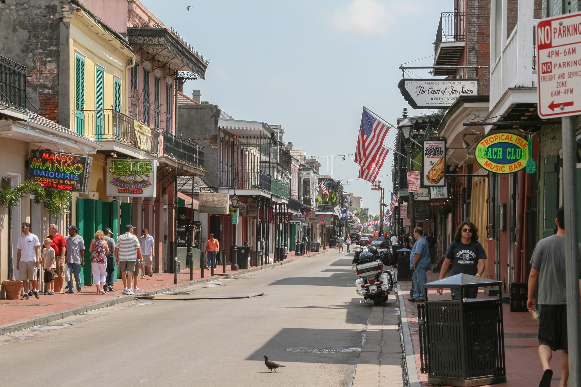 A historic street lined with ornate ironwork balconies