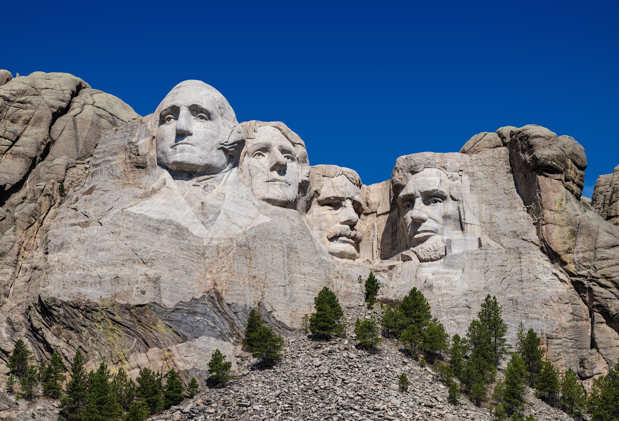 Four enormous presidential faces carved into a granite mountainside