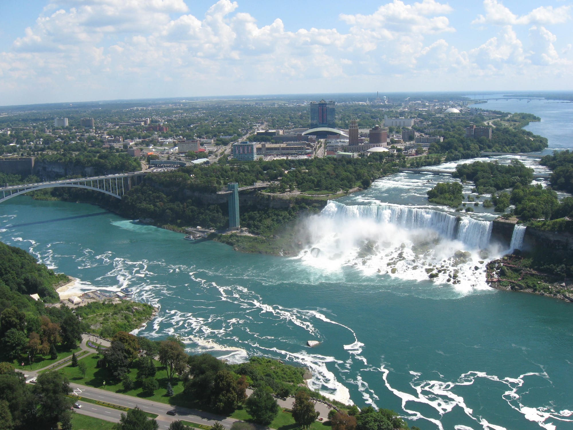 A massive waterfall with mist rising from the base