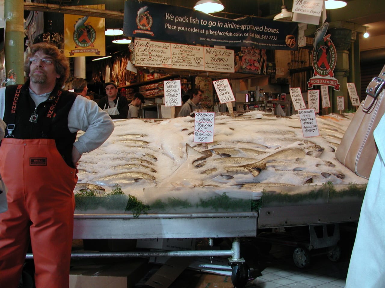 A fish market with vendors and fresh fish on display