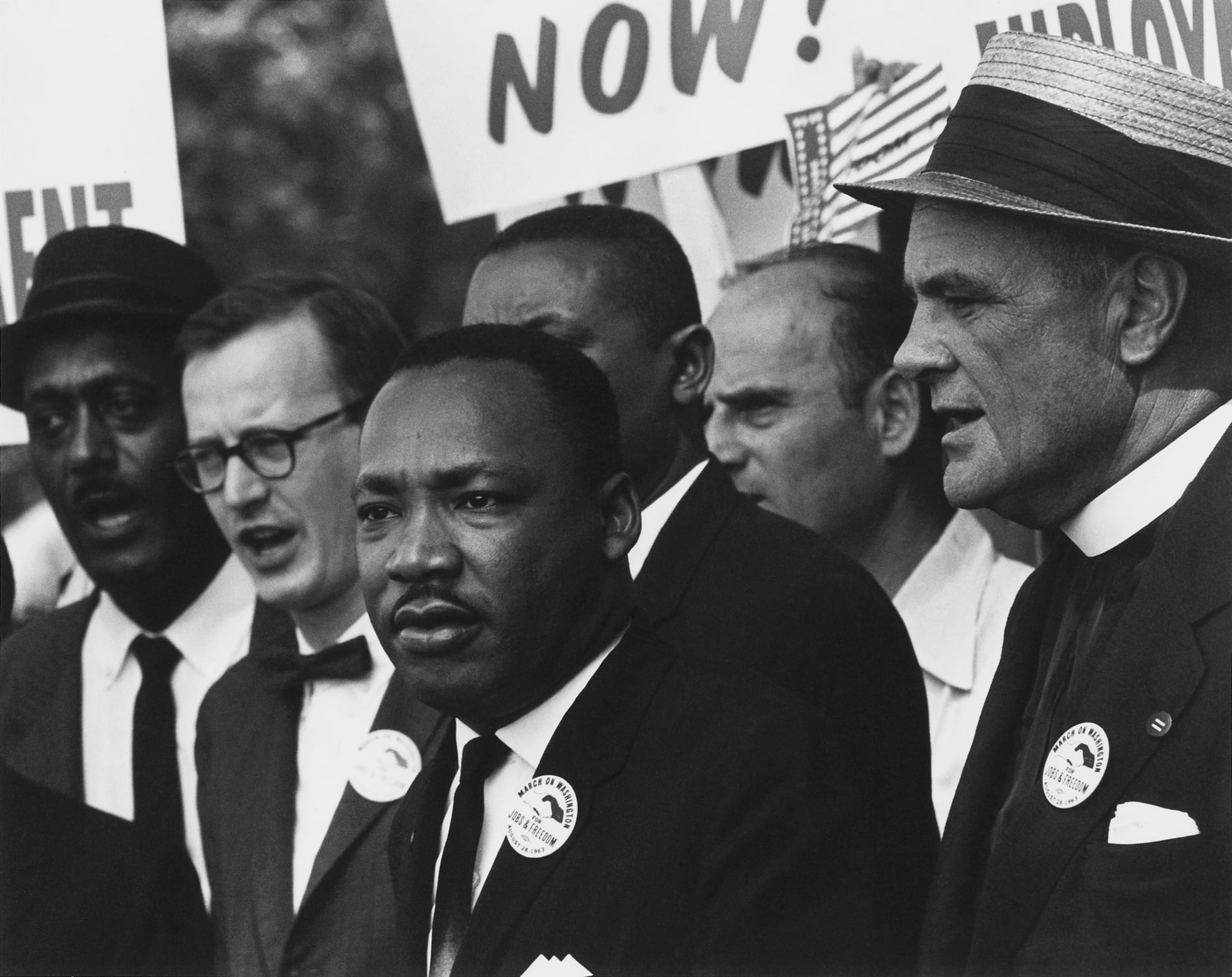 Martin Luther King Jr. in a suit amid a dense crowd at the 1963 March on Washington