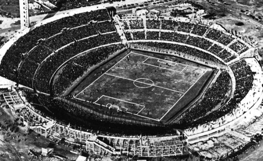 A packed 1930 stadium crowd watching the first football World Cup final in Montevideo