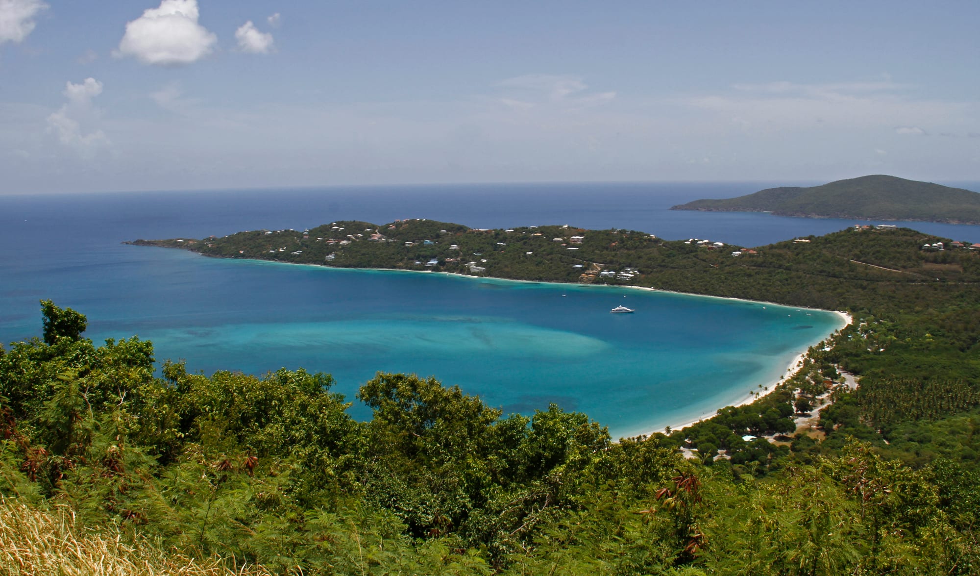 A wide crescent beach along a sheltered bay
