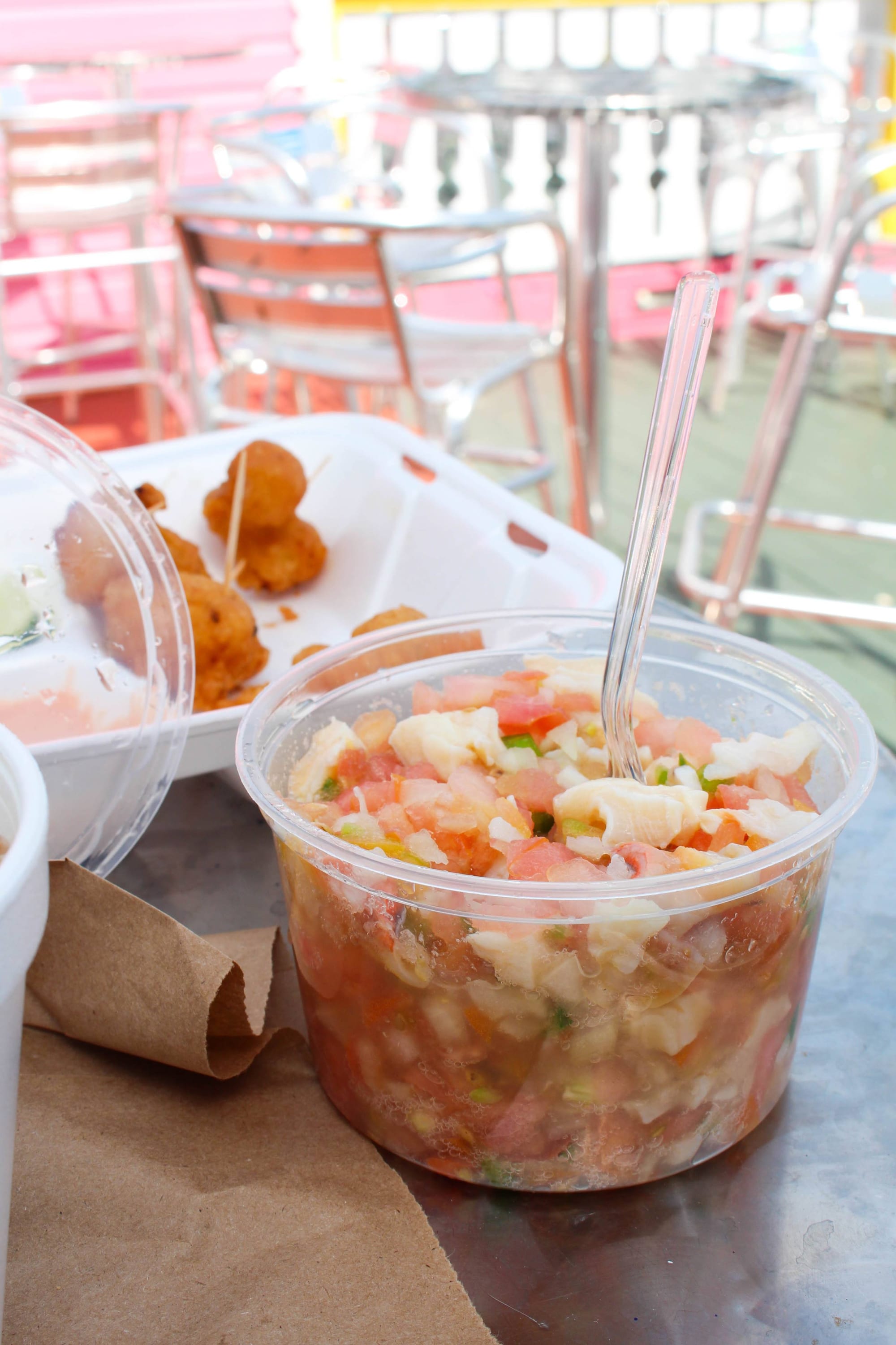 Conch fritters and conch salad served in takeaway containers