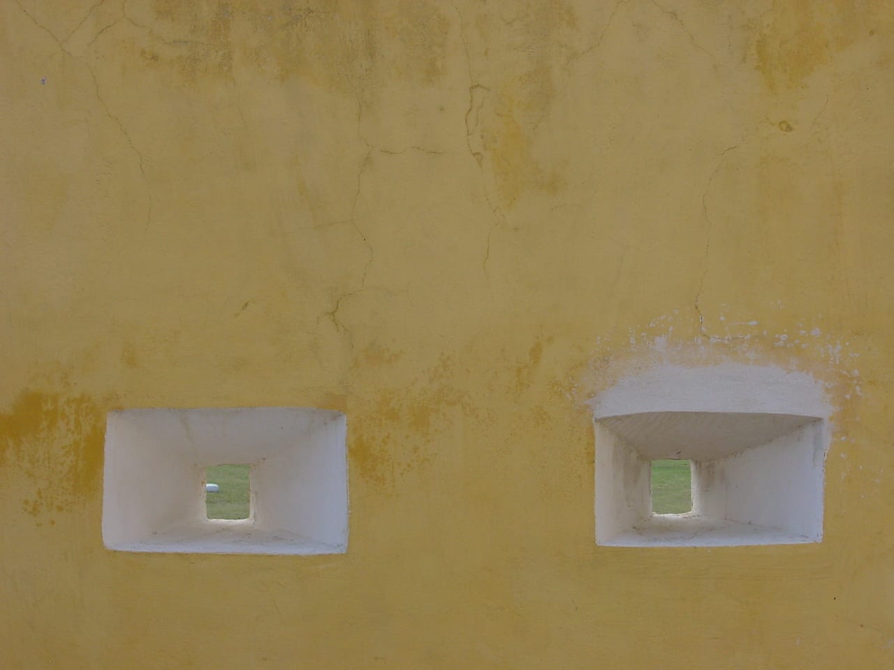 A yellow-ochre Danish colonial fort with cannon and ramparts overlooking the harbour at Christiansted, St Croix