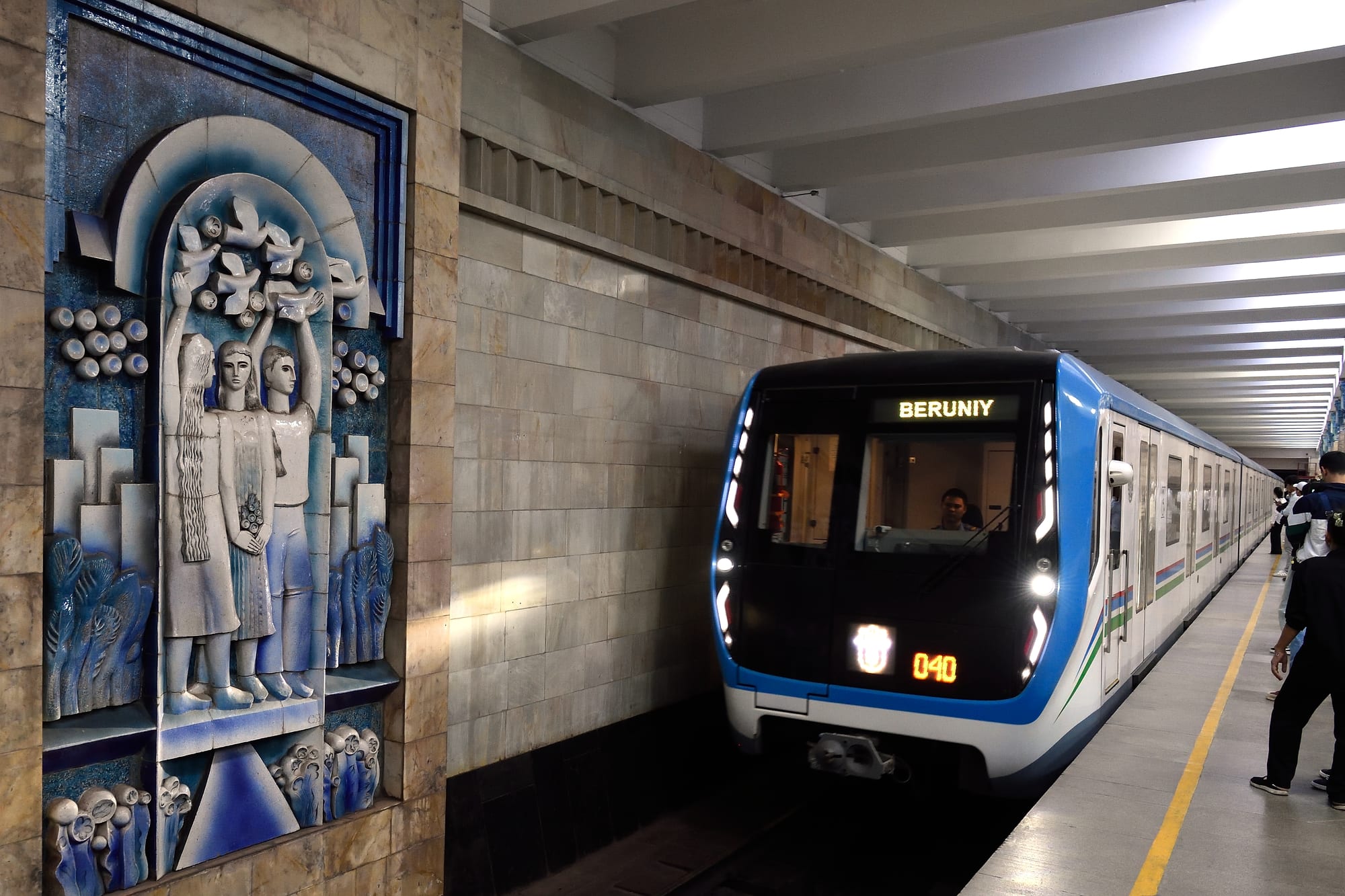 An ornately decorated underground metro station with chandeliers