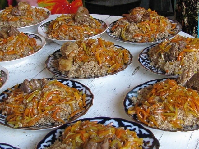 A large platter of spiced rice with meat and carrots