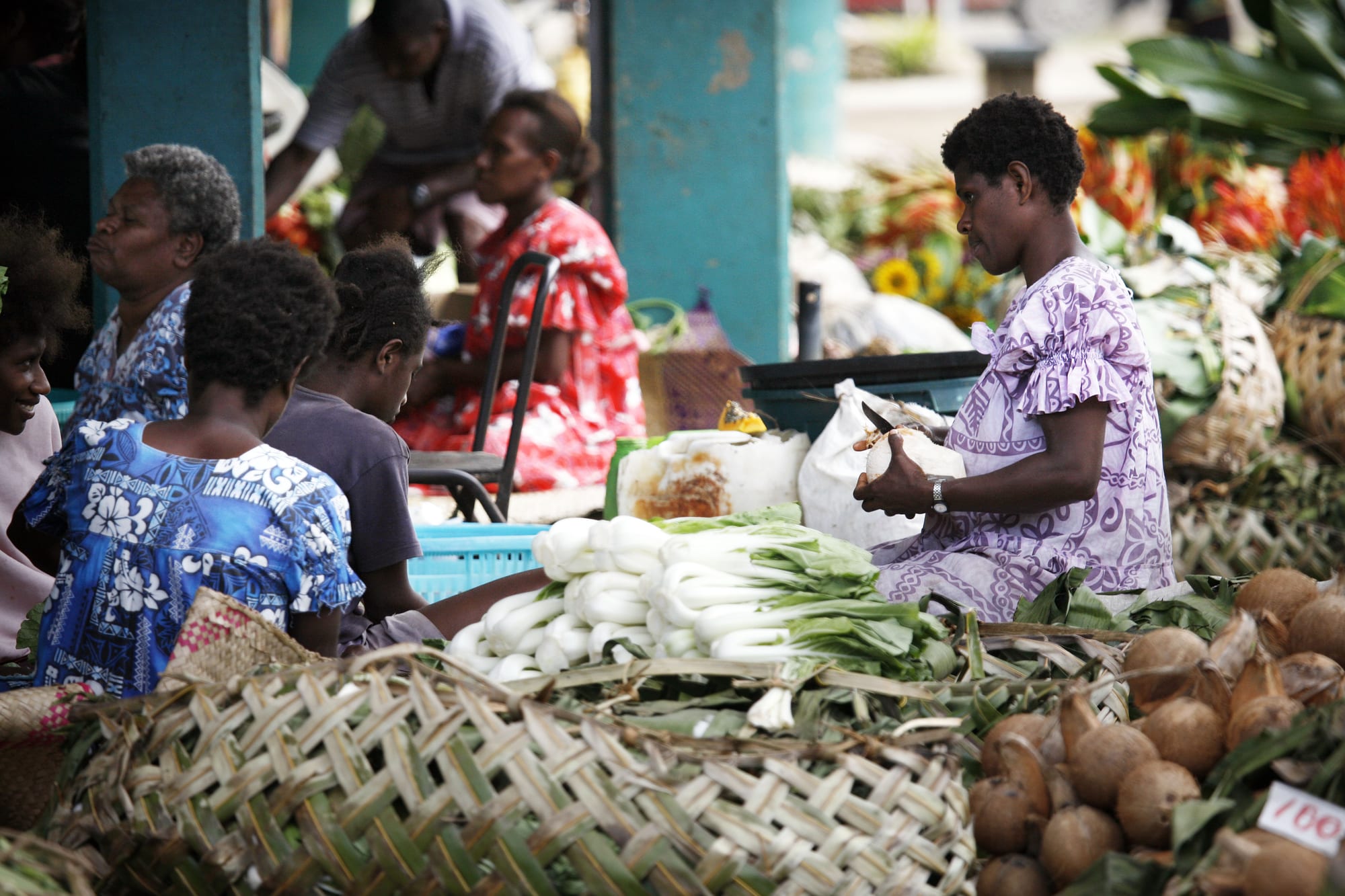 A busy outdoor market with fresh produce for sale