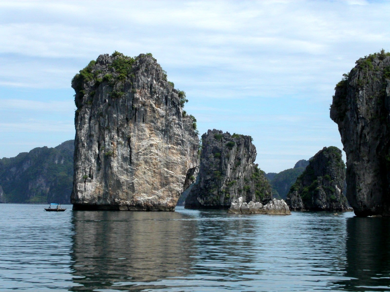 Thousands of limestone karst islands rising from calm emerald water