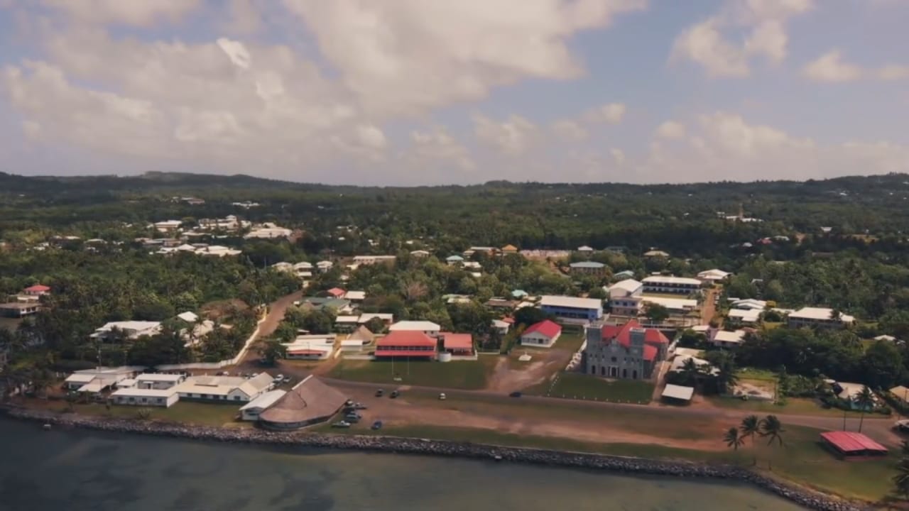 A small coastal town with a cathedral, seen from above