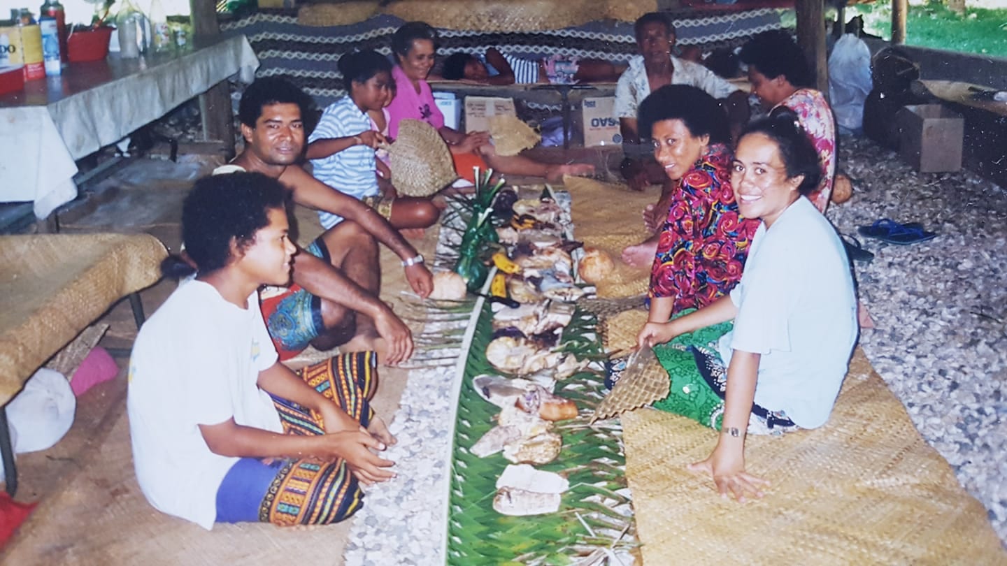 A family meal spread on the ground