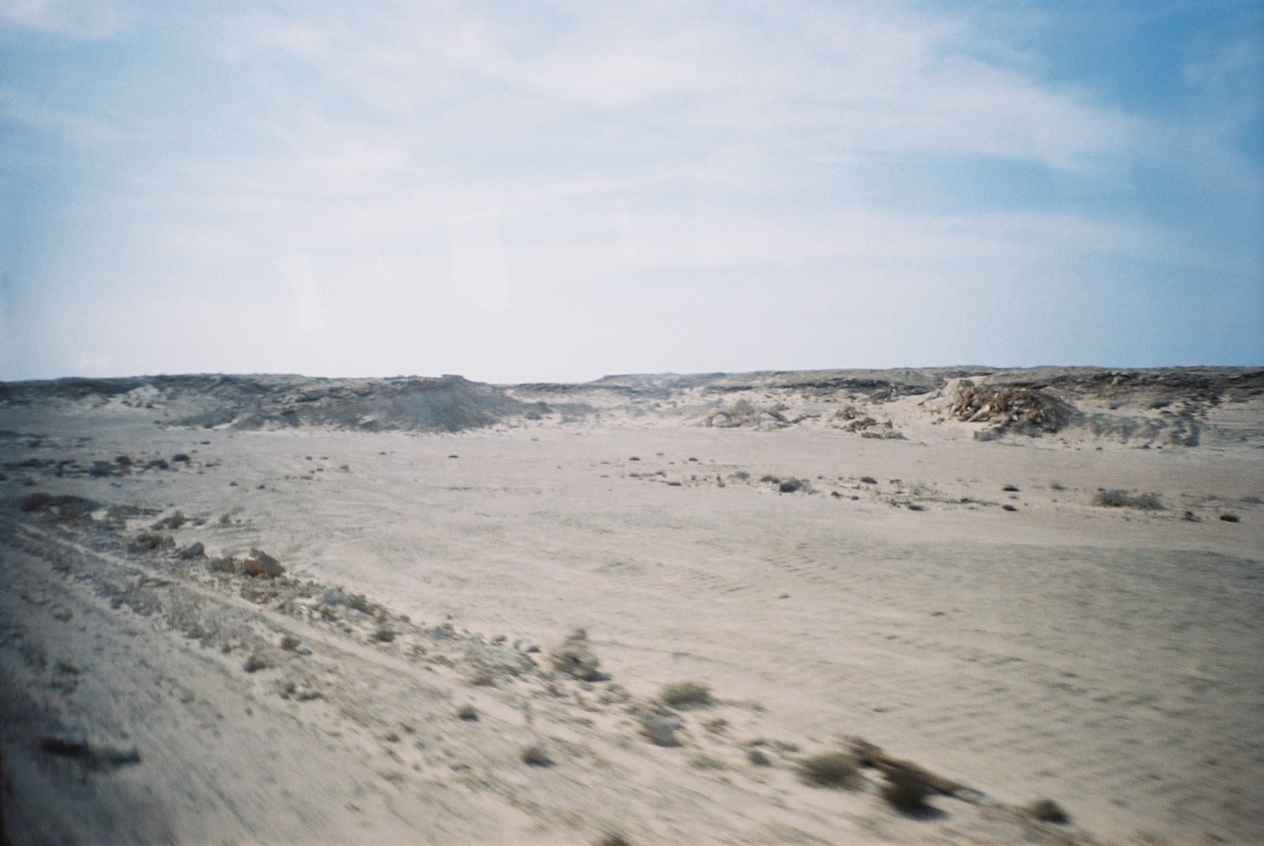 A vast, empty desert landscape stretching to the horizon