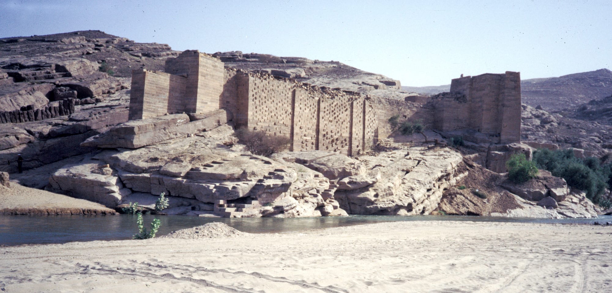 The ruined stone sluice and pillars of the ancient Great Dam of Marib in the desert