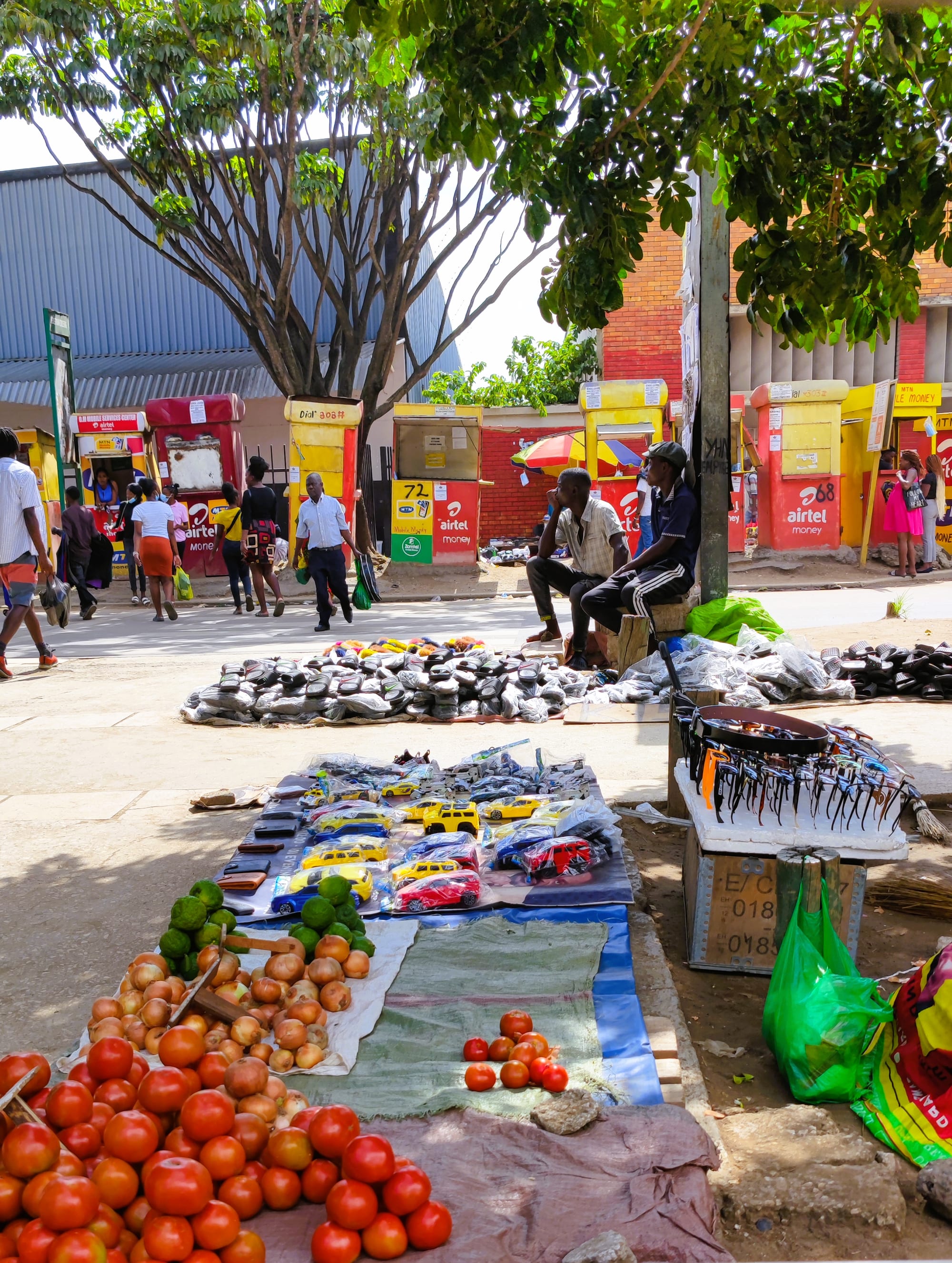 A busy street market with vendors and shoppers along Lusaka's main thoroughfare
