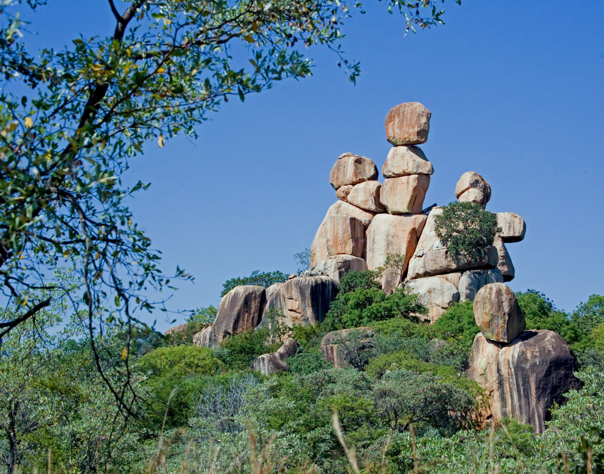 Ancient balancing granite boulders rising above the bush