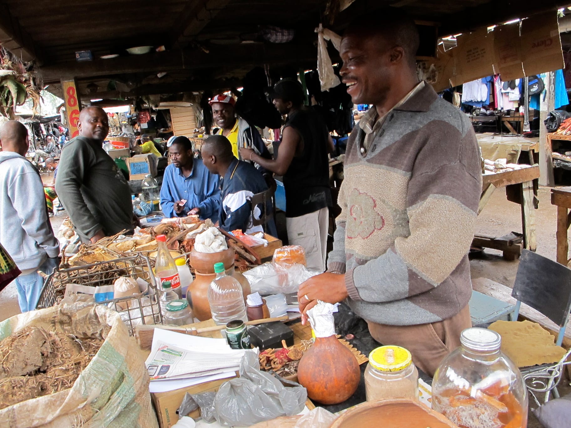 An outdoor market with vendors and produce