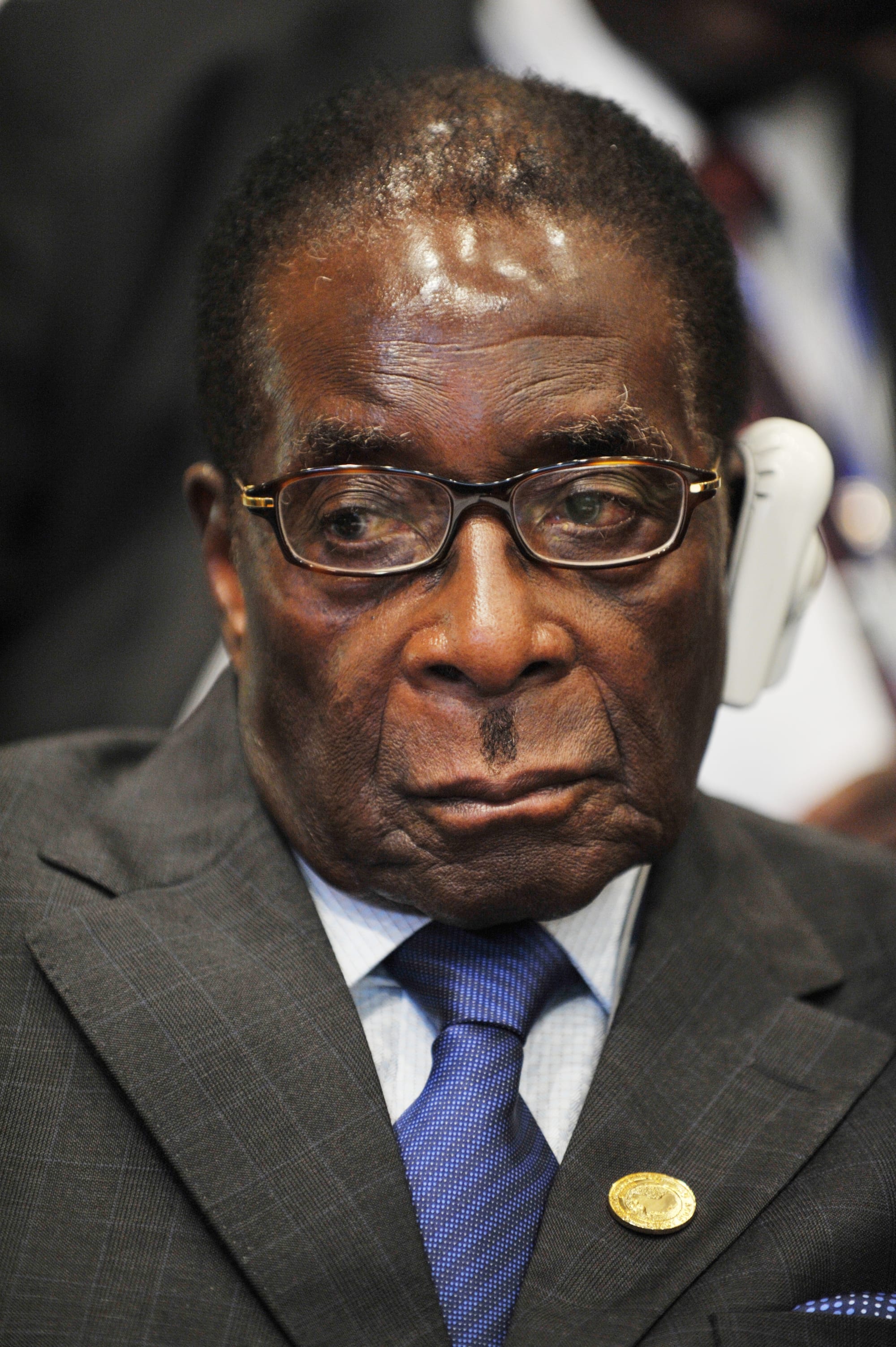Robert Mugabe in a dark suit speaking at a lectern at an African Union summit