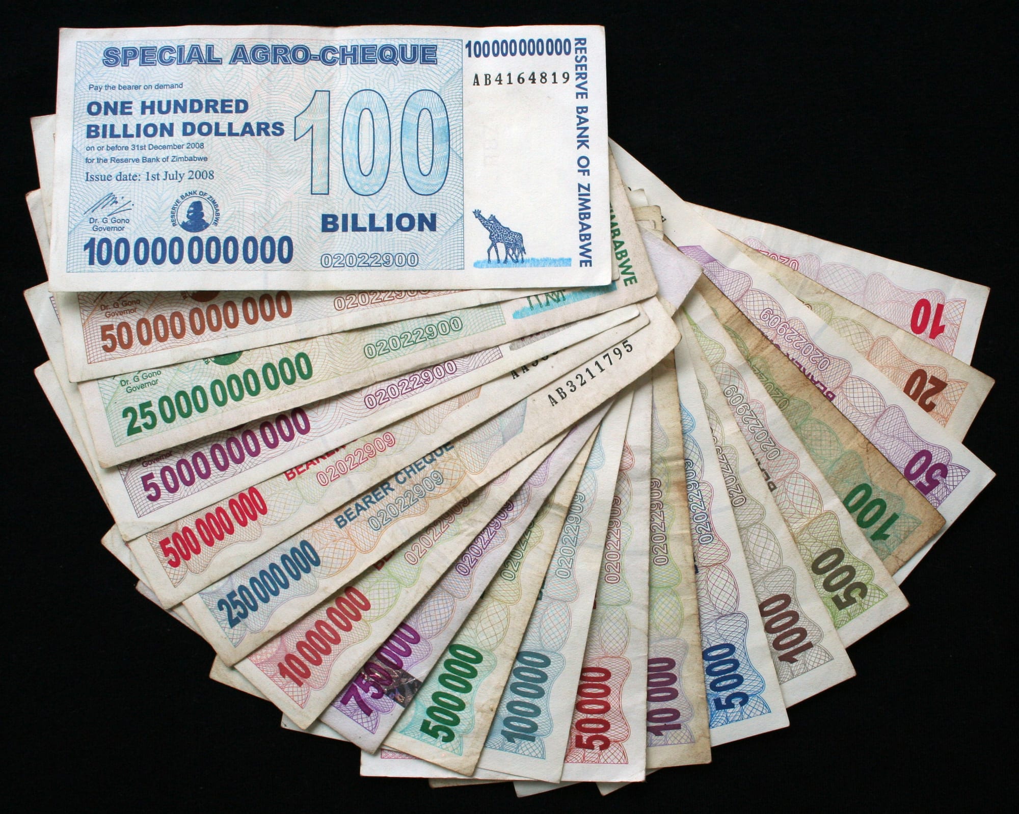 A spread of Zimbabwean banknotes in denominations up to hundreds of trillions of dollars
